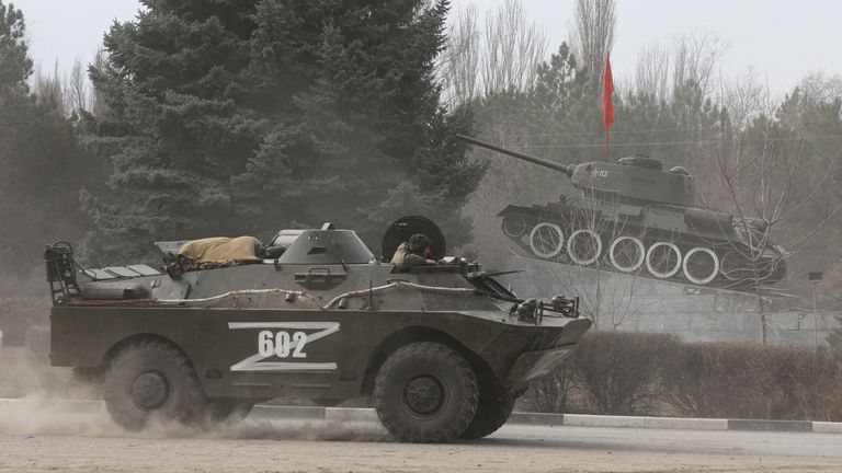 Russian Army military vehicle with the letter &#39;Z&#39; on it drives past a monument displaying a Soviet-era tank, after Russian President Vladimir Putin authorized a military operation in eastern Ukraine, in the town of Armyansk, Crimea, February 24, 2022. REUTERS/Stringer
