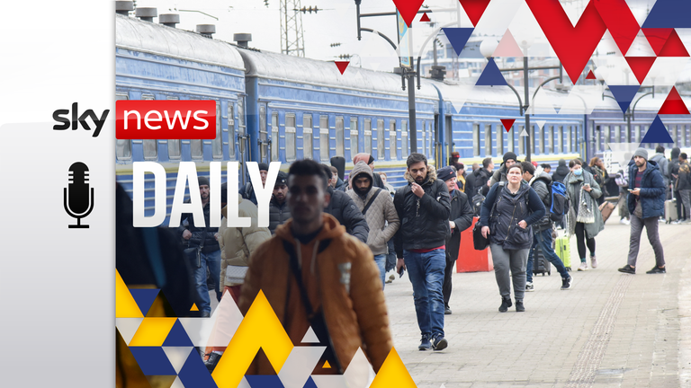 Passengers, including evacuees from the cities of Sumy and Kyiv, walk along the platform of a railway station upon their arrival in Lviv, Ukraine February 25, 2022. 