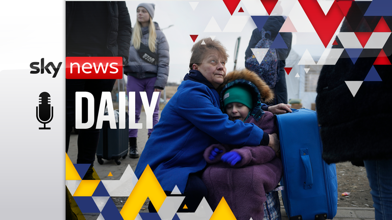 A woman holds a small girl at a border crossing, up as refugees flee a Russian invasion