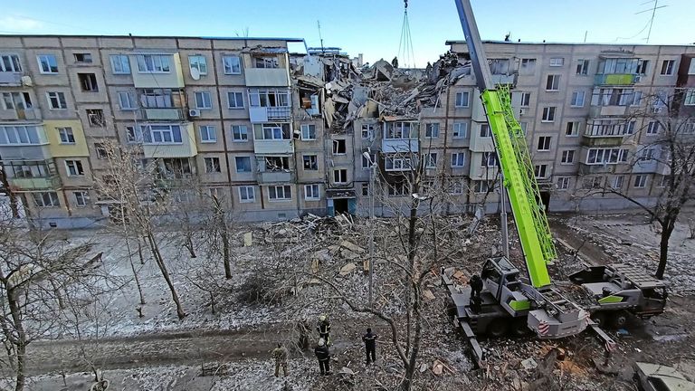 Rescuers remove debris from a residential building damaged by an airstrike, as Russia?s attack on Ukraine continues, in Kharkiv, Ukraine March 15, 2022. REUTERS/Vitalii Hnidyi
