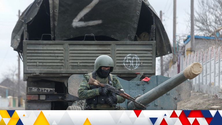 A service member of pro-Russian troops in a uniform without insignia walks past a truck with the letter "Z" painted on its tent top in the separatist-controlled settlement of Buhas (Bugas), as Russia&#39;s invasion of Ukraine continues, in the Donetsk region, Ukraine March 1, 2022. REUTERS/Alexander Ermochenko
