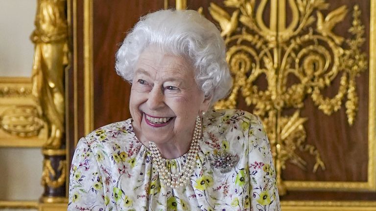 Embargoed to 2230 Thursday March 24 Queen Elizabeth II smiles as she arrives to view a display of artefacts from British craftwork company, Halcyon Days, to commemorate the company&#39;s 70th anniversary in the White Drawing Room at Windsor Castle, Berkshire. Picture date: Wednesday March 23, 2022.
