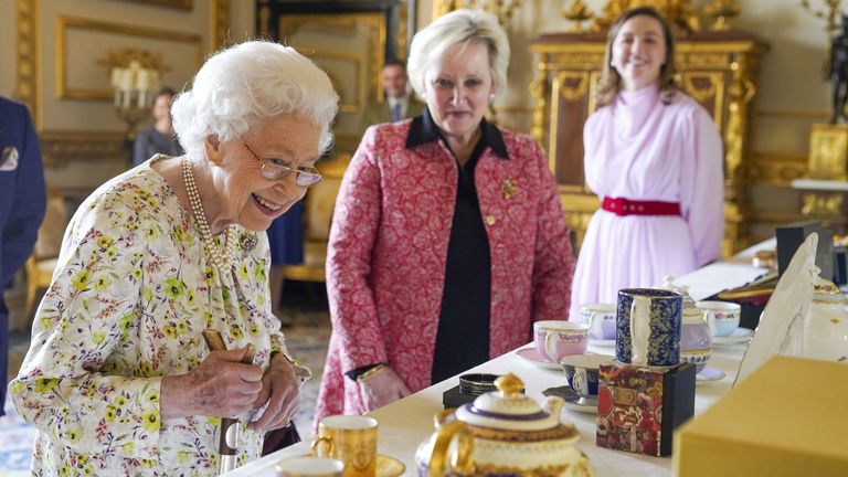 Embargoed to 2230 Thursday March 24 Queen Elizabeth II views a display of artefacts from British craftwork company, Halcyon Days, to commemorate the company&#39;s 70th anniversary in the White Drawing Room at Windsor Castle, Berkshire. Picture date: Wednesday March 23, 2022.
