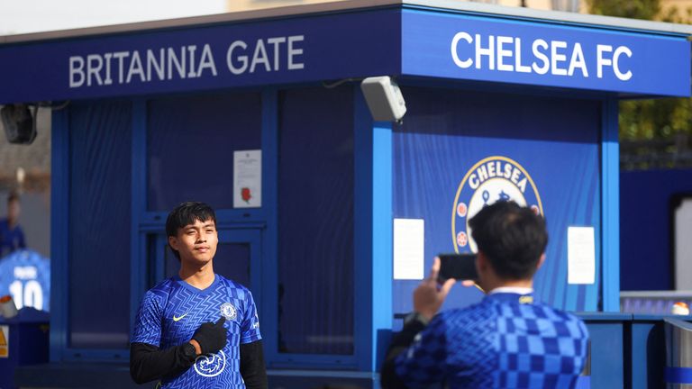 A person has his picture taken outside Stamford Bridge, the stadium for Chelsea Football Club, after Britain imposed sanctions on its Russian owner, Roman Abramovich, in London, Britain, March 10, 2022. REUTERS/Hannah Mckay
