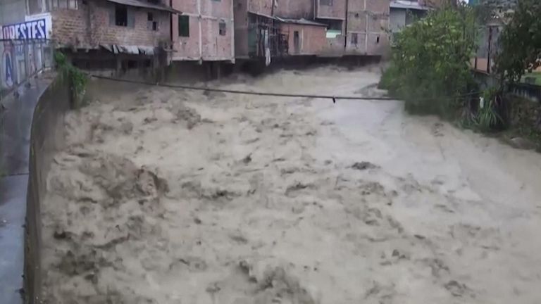 Video shows water rushing through Lajas, Peru destroying buildings and vehicles.