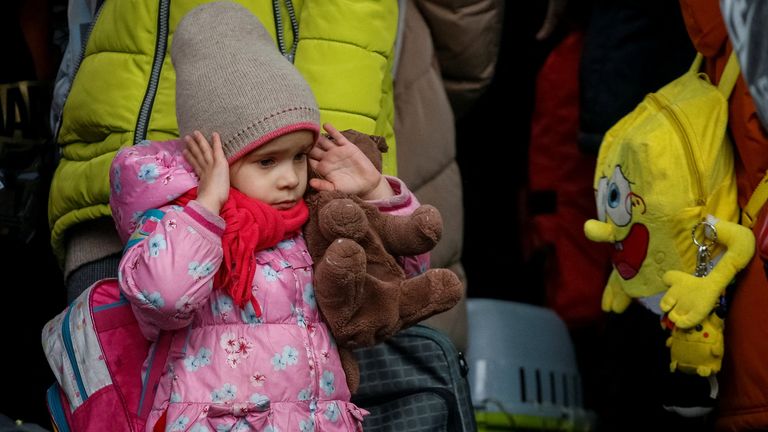 A girl reacts during air raid signal as people wait to board an evacuation train from Kyiv to Lviv, at Kyiv central train station, following Russia&#39;s invasion of Ukraine, in Kyiv, Ukraine March 2, 2022. REUTERS/Gleb Garanich
