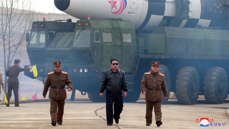 North Korean leader Kim Jong Un walks away from what state media report is a "new type" of intercontinental ballistic missile (ICBM)
