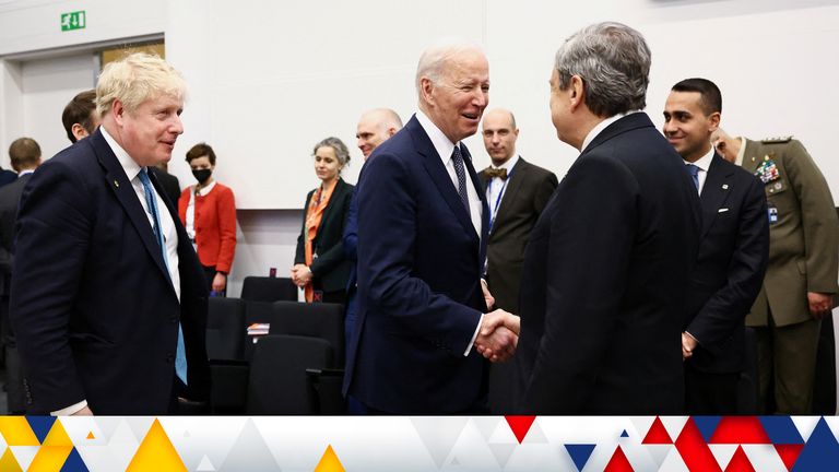 President Joe Biden, next to Boris Johnson, shakes hands with Italy&#39;s PM Mario Draghi during a NATO summit on Russia&#39;s invasion of Ukraine