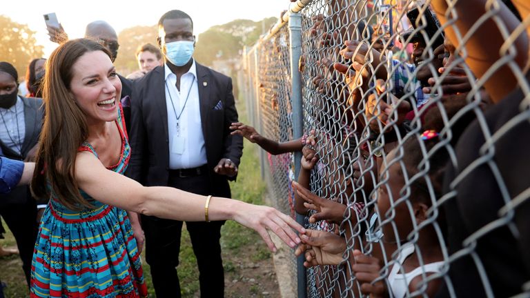 Catherine, Duchess of Cambridge shakes hands with children during a visit to Trench Town, the birthplace of reggae music, on day four of the Platinum Jubilee Royal Tour of the Caribbean in Kingston, Jamaica, March 22, 2022. Chris Jackson/Pool via REUTERS