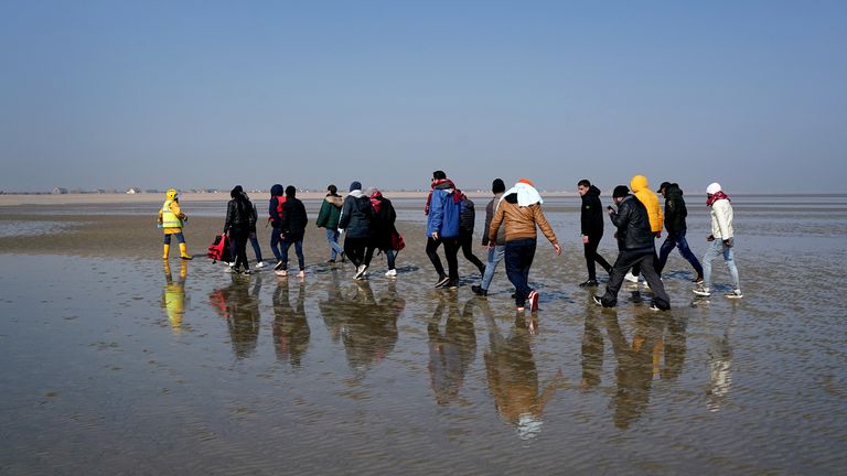 A group of people thought to be migrants are are guided up the beach after being brought in to Dungeness, Kent, onboard the RNLI Lifeboat following a small boat incident in the Channel. Picture date: Thursday March 24, 2022.