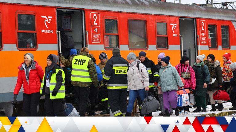 Polish army soldiers and volunteers assist people board a train to Krakow following crossing the border from Ukraine to Poland, after fleeing the Russian invasion of Ukraine, at the border checkpoint in Medyka, Poland, March 9, 2022. REUTERS/Fabrizio Bensch
