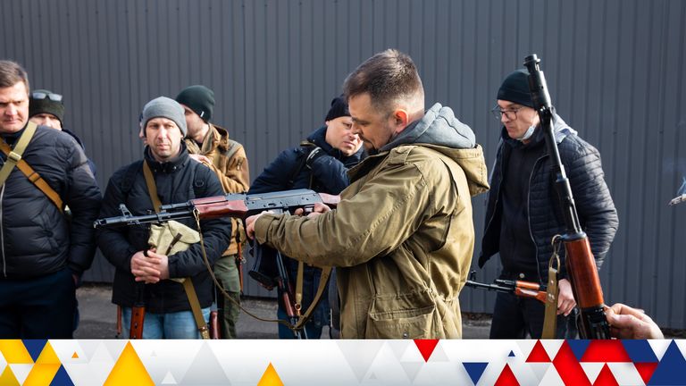Civilian members of a territorial defence unit checking their weapons in Kyiv on Saturday. Pic: AP
