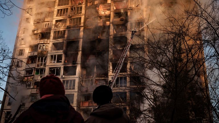 Ukrainian firefighters work in an apartment building following bombing in Kyiv. Pic: AP