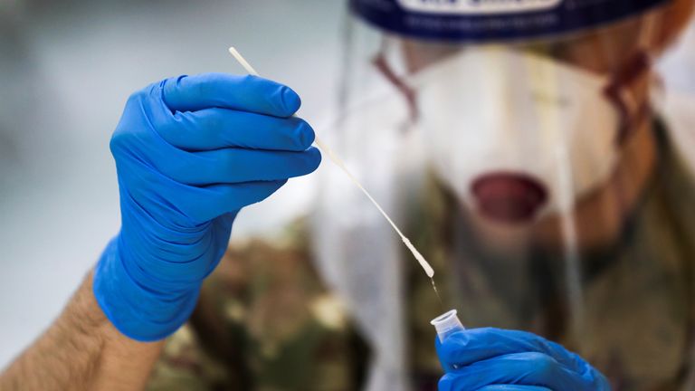 A member of the British Royal Air Force holds a lateral flow antigen test swab sample, amid the spread of the coronavirus disease (COVID-19), in Newcastle upon Tyne, Britain, November 25, 2020. REUTERS/Lee Smith