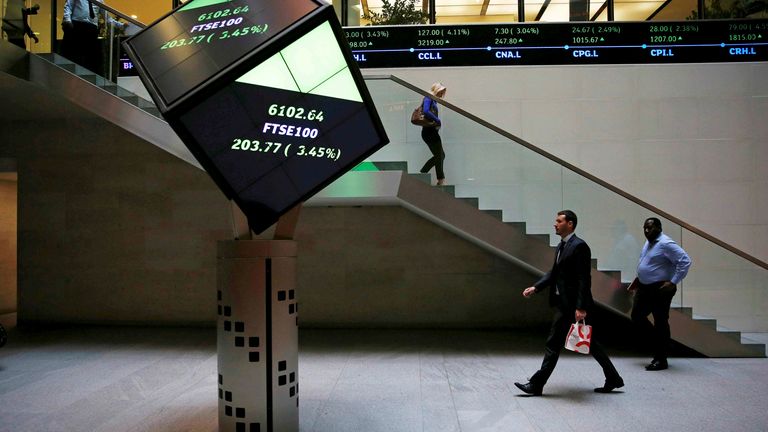 People walk through the lobby of the London Stock Exchange in London, Britain August 25, 2015. REUTERS/Suzanne Plunkett/File photo
