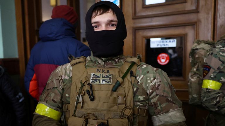 A foreign fighter from the UK asked to be identified as "Jacks" poses for a picture, as he and other volunteers are ready to depart towards the front line in the east of Ukraine following the Russian invasion, at the main train station in Lviv, Ukraine, March 5, 2022. Picture taken March 5, 2022. REUTERS/Kai Pfaffenbach
