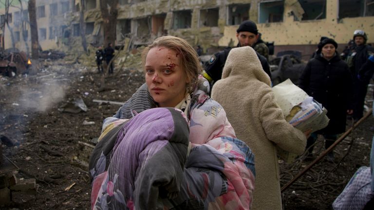 Mariana Vishegirskaya stands outside a maternity hospital that was damaged by shelling in Mariupol - she later gave birth to a girl in another hospital in the besieged city. Pic: AP