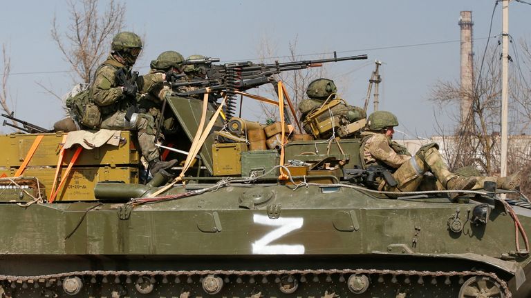 Service members of pro-Russian troops are seen atop of an armoured vehicle with a symbol "Z" painted on its side in the course of Ukraine-Russia conflict in the besieged southern port city of Mariupol, Ukraine March 24, 2022. REUTERS/Alexander Ermochenko
