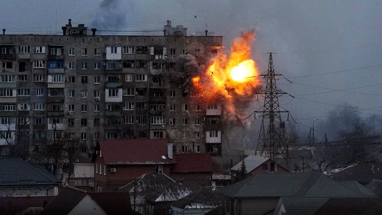 An explosion is seen in a residential apartment block in Mariupol after a Russian army tank appears to fire directly at the building. Pic: AP