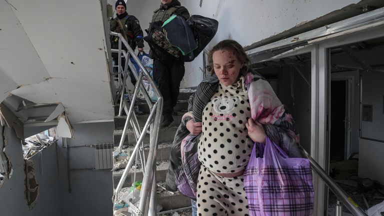 Mariana Vishegirskaya walks downstairs in of a maternity hospital damaged by shelling in Mariupol, Ukraine, Wednesday, March 9, 2022. Vishegirskaya survived the shelling and later delivered a baby girl in another hospital. (AP Photo/Evgeniy Maloletka)