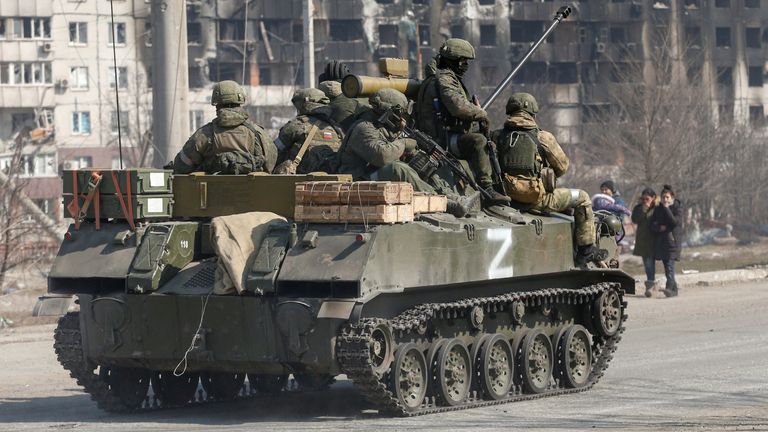 Service members of pro-Russian troops are seen atop of an armoured vehicle with the symbol "Z" painted on its side in the course of Ukraine-Russia conflict in the besieged southern port city of Mariupol, Ukraine March 24, 2022. REUTERS/Alexander Ermochenko
