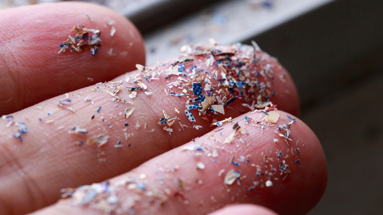 A close up image of microplastics on a person's hand. Pic: iStock