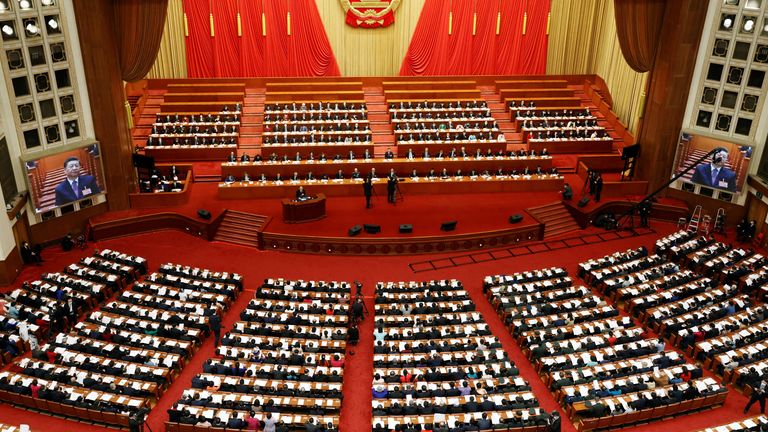 Chinese President Xi Jinping are seen on screens as delegates attend the second plenary session of the National People&#39;s Congress (NPC) at the Great Hall of the People in Beijing, China March 8, 2022. REUTERS/Carlos Garcia Rawlins
