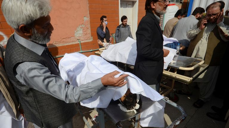 People gather to identify the relatives, who were killed, after a bomb blast in a mosque during Friday prayers, at a hospital in Peshawar, Pakistan, March 4, 2022. REUTERS/Khuram Parvez
