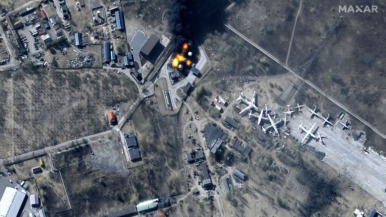 Satellite image shows damage to buildings and fuel storage tanks on fire at Antonov Airport