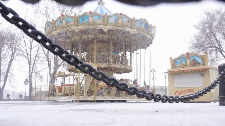 A carnival merry-go-round ride on the promenade that overlooks the port has frozen solid