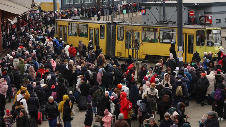 Refugees fleeing the ongoing Russian invasion of Ukraine wait for hours to board a train to Poland, outside the train station in Lviv, Ukraine, March 8, 2022. REUTERS/Kai Pfaffenbach 