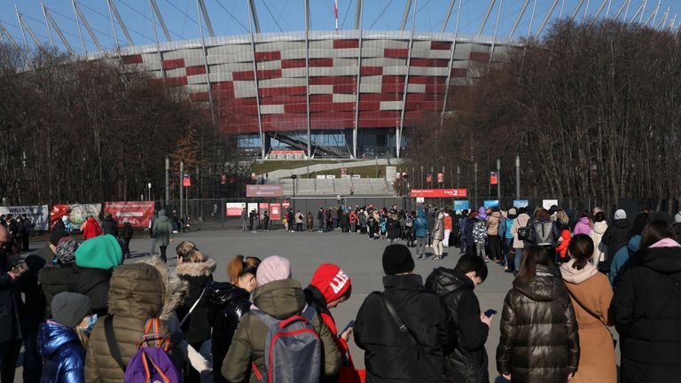 Refugees who fled Ukraine queue to register at Poland&#39;s national stadium