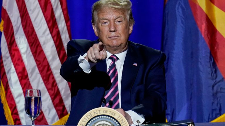 President Donald Trump points to the crowd as he participates in a Latinos for Trump Coalition roundtable Monday, Sept. 14, 2020, in Phoenix. (AP Photo/Ross D. Franklin)