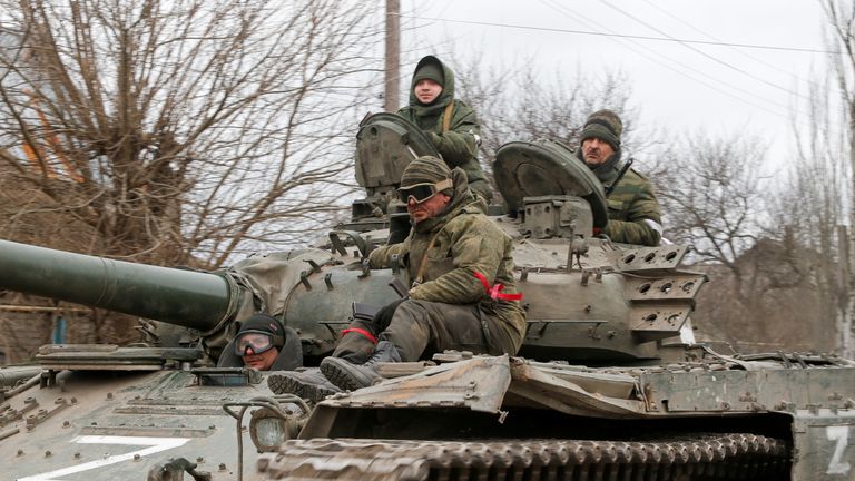 Service members of pro-Russian troops in uniforms without insignia are seen atop of a tank with the letter "Z" painted on its sides in the separatist-controlled settlement of Buhas (Bugas), as Russia's invasion of Ukraine continues, in the Donetsk region, Ukraine March 1, 2022. REUTERS/Alexander Ermochenko
