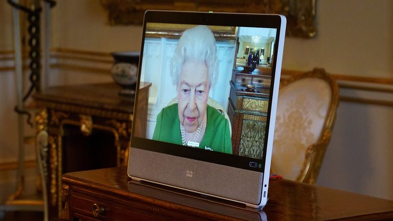 The Queen appears on a screen via videolink from Windsor Castle