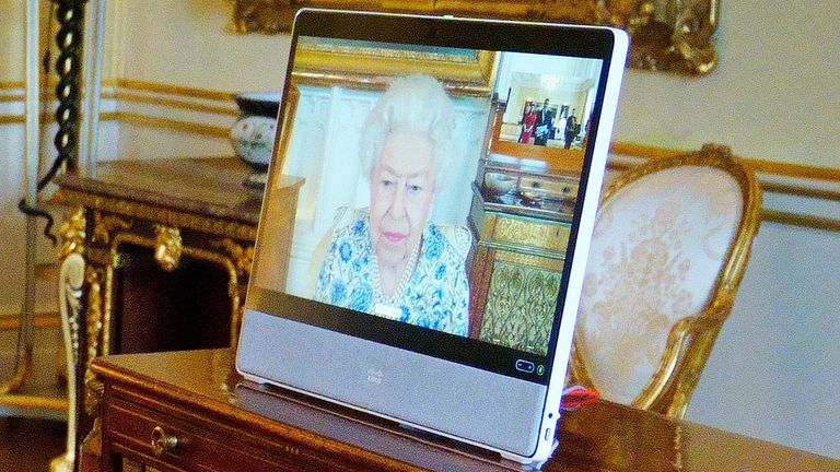 Queen Elizabeth II appears on a screen via videolink from Windsor Castle, where she is in residence, during a virtual audience to receive the High Commissioner of Trinidad and Tobago, Vishnu Dhanpaul, at Buckingham Palace, London.