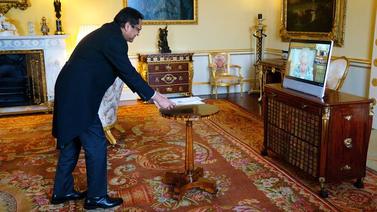 Queen Elizabeth II appears on a screen via videolink from Windsor Castle, where she is in residence, during a virtual audience to receive the High Commissioner of Trinidad and Tobago, Vishnu Dhanpaul, at Buckingham Palace, London.
