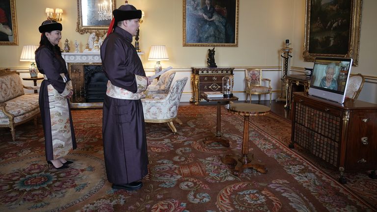 Queen Elizabeth II appears on a screen via videolink from Windsor Castle, where she is in residence, during a virtual audience to receive His Excellency Enkhsukh Battumur, Ambassador of Mongolia, and his wife Ganchimeg Purevdorj, at Buckingham Palace, London. Picture date: Tuesday March 15, 2022.
