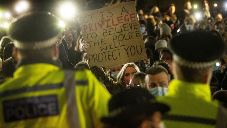 A woman holds up a banner as people gather in Clapham Common, London, after the Love These Streets vigil for Sarah Everard was officially cancelled.