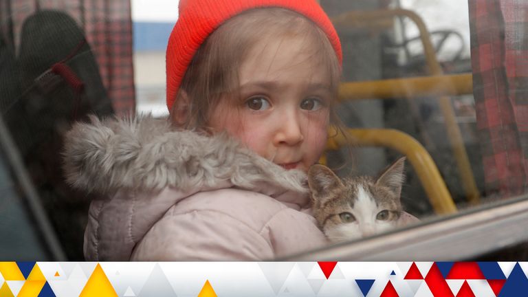 Rimma, a three-year-old girl evacuated from Mariupol area, holds a cat in a bus before leaving a refugee camp in the settlement of Bezymennoye for the territory of Russia during Ukraine-Russia conflict in the Donetsk region, Ukraine March 8, 2022. REUTERS/Alexander Ermochenko