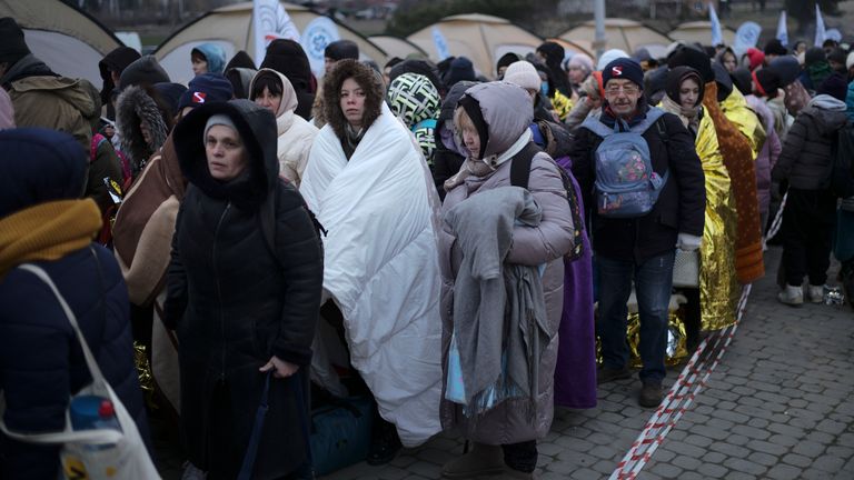 Refugees wait in a crowd for transport after fleeing from the Ukraine and arriving at the border crossing in Medyka, Poland, Monday, March 7, 2022. (AP Photo/Markus Schreiber)
Pic:AP