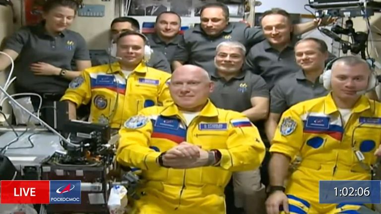 Russian cosmonauts Sergey Korsakov, Oleg Artemyev and Denis Matveyev during a welcome ceremony after arriving at the International Space Station, on Friday, wearing yellow flight suits in the colours of the Ukrainian flag