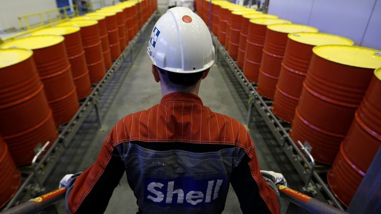 An employee stands in front of lines of oil barrels at Royal Dutch Shell Plc&#39;s lubricants blending plant in the town of Torzhok, north-west of Tver, November 7, 2014. Picture taken November 7, 2014. REUTERS/Sergei Karpukhin (RUSSIA - Tags: BUSINESS INDUSTRIAL)
