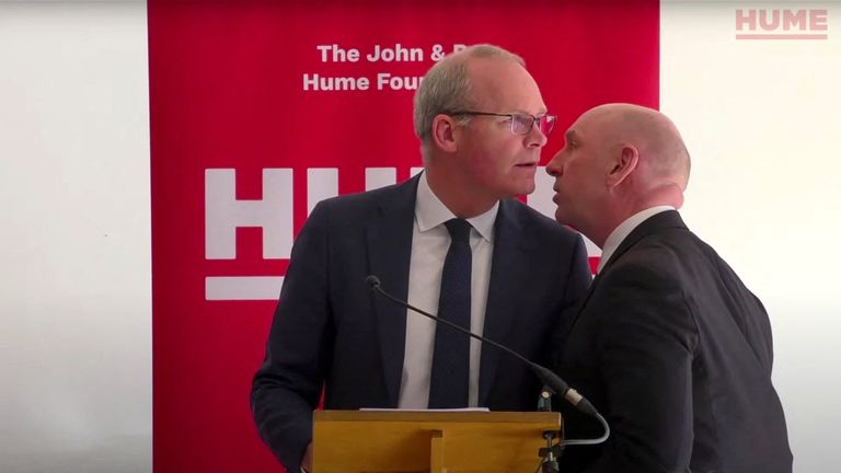 Irish Foreign Minister Simon Coveney learns about a potential security threat during his speech at &#39;Building Common Ground&#39; event. Pic: The John And Pat Hume Foundation