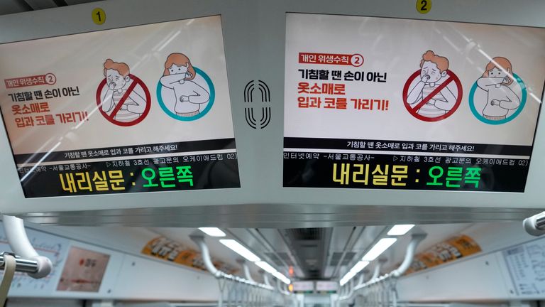 Digital screens showing precautions against the coronavirus in a subway train in in Seoul 