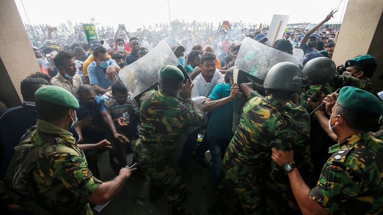 Special Task Force members push back the people who are blocking the main road in front of the President's secretariat during a protest organized by main opposition party Samagi Jana Balawegaya against the worsening economic crisis that has brought fuel shortages and spiralling food prices in Colombo, Sri Lanka March 15, 2022. REUTERS/Dinuka Liyanawatte
