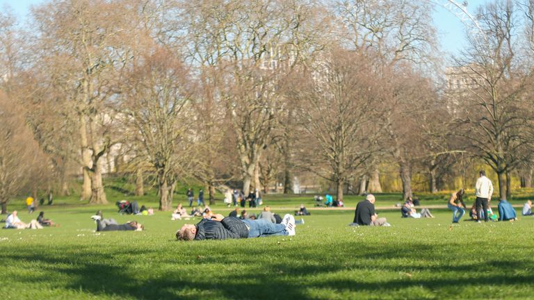 People enjoy fine weather in St James&#39; Park, central London