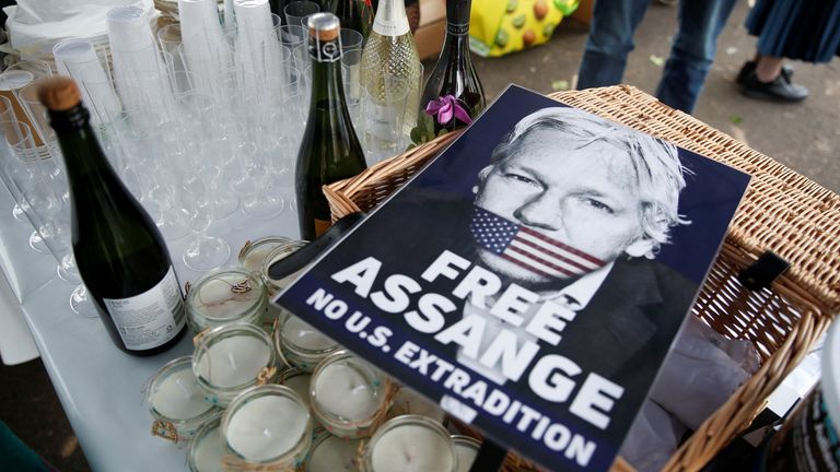 A view shows a placard depicting WikiLeaks founder Julian Assange, near bottles of sparkling wine belonging to his supporters, on the day of his and Stella Moris&#39; wedding at HMP Belmarsh prison, in London, Britain, March 23, 2022. REUTERS/Peter Nicholls
