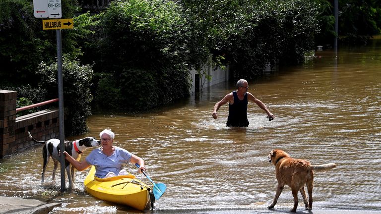 A resident paddles through floodwater as a road is submerged in Windsor, north-west of Sydney, Australia, March 9, 2022. AAP Image/Bianca De Marchi via REUTERS ATTENTION EDITORS - THIS IMAGE WAS PROVIDED BY A THIRD PARTY. NO RESALES. NO ARCHIVE. AUSTRALIA OUT. NEW ZEALAND OUT
