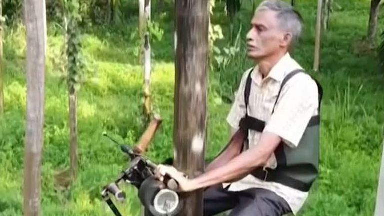 Ganapathi Bhat demonstrates his invention - the tree-climbing scooter